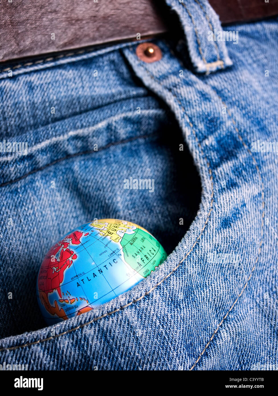 Globe in the pocket as a metaphor about eternal desire about world possession... Stock Photo