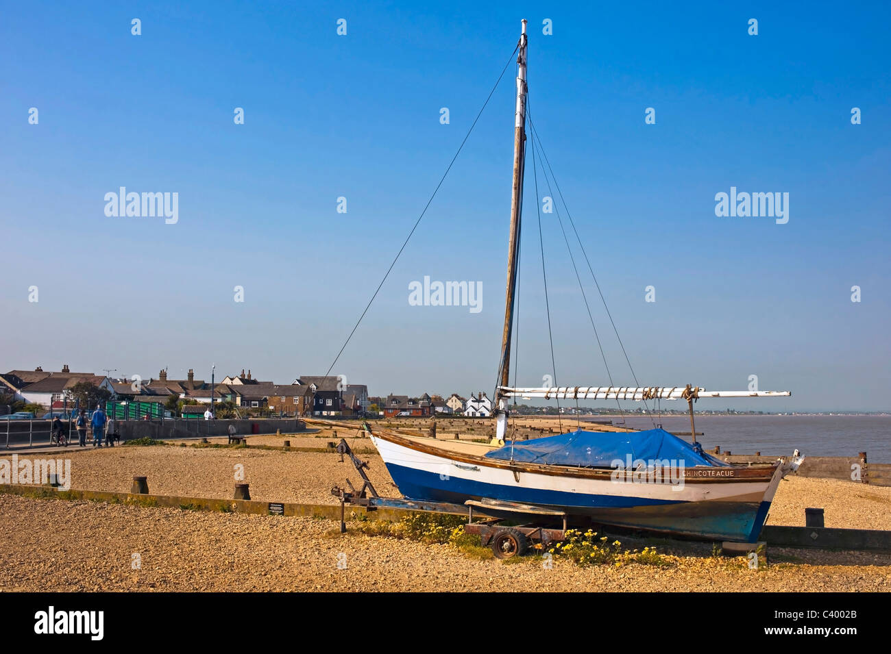 beached skiff type sailing Boat on Whitstable beach, Kent Stock Photo