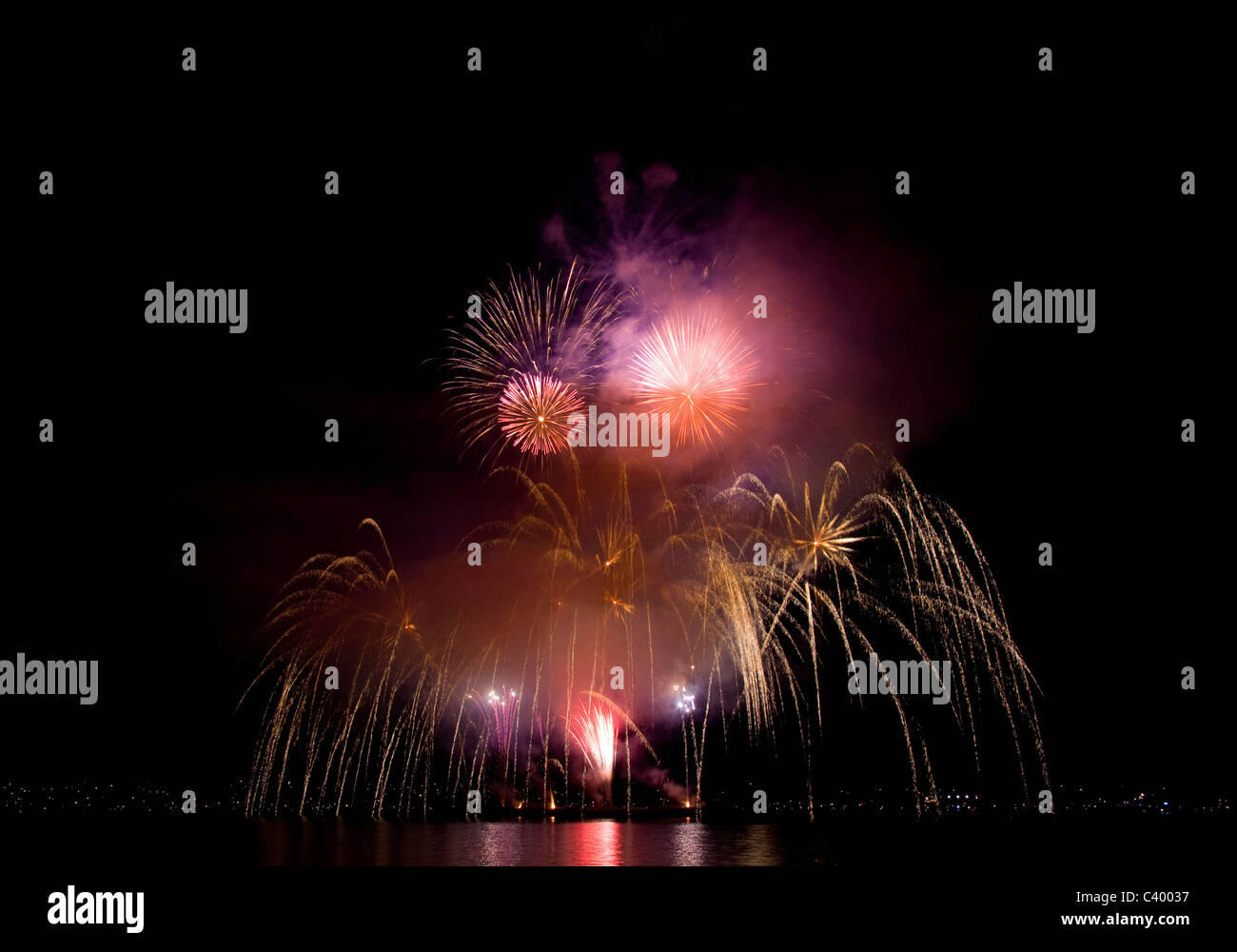 An explosion of purple and gold Fireworks during the Celebration of Light in English Bay, Vancouver. Stock Photo