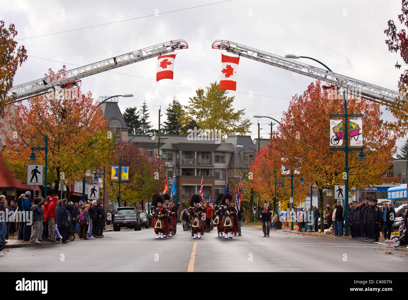 Pipe band marches under flags suspend from fire ladders, 2009