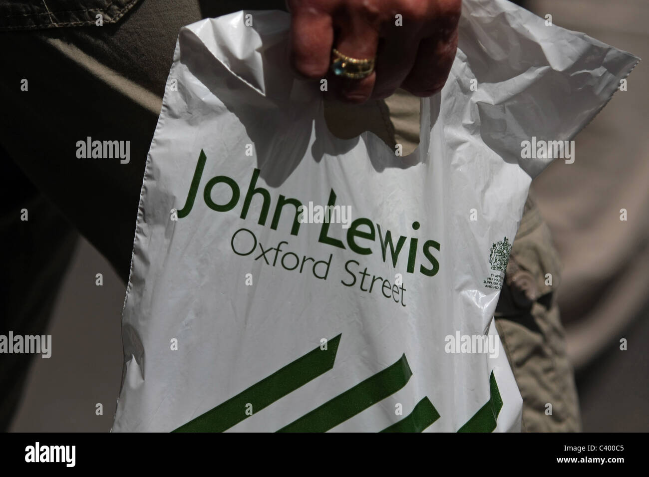A plastic John Lewis shopping bag being carried Stock Photo Alamy