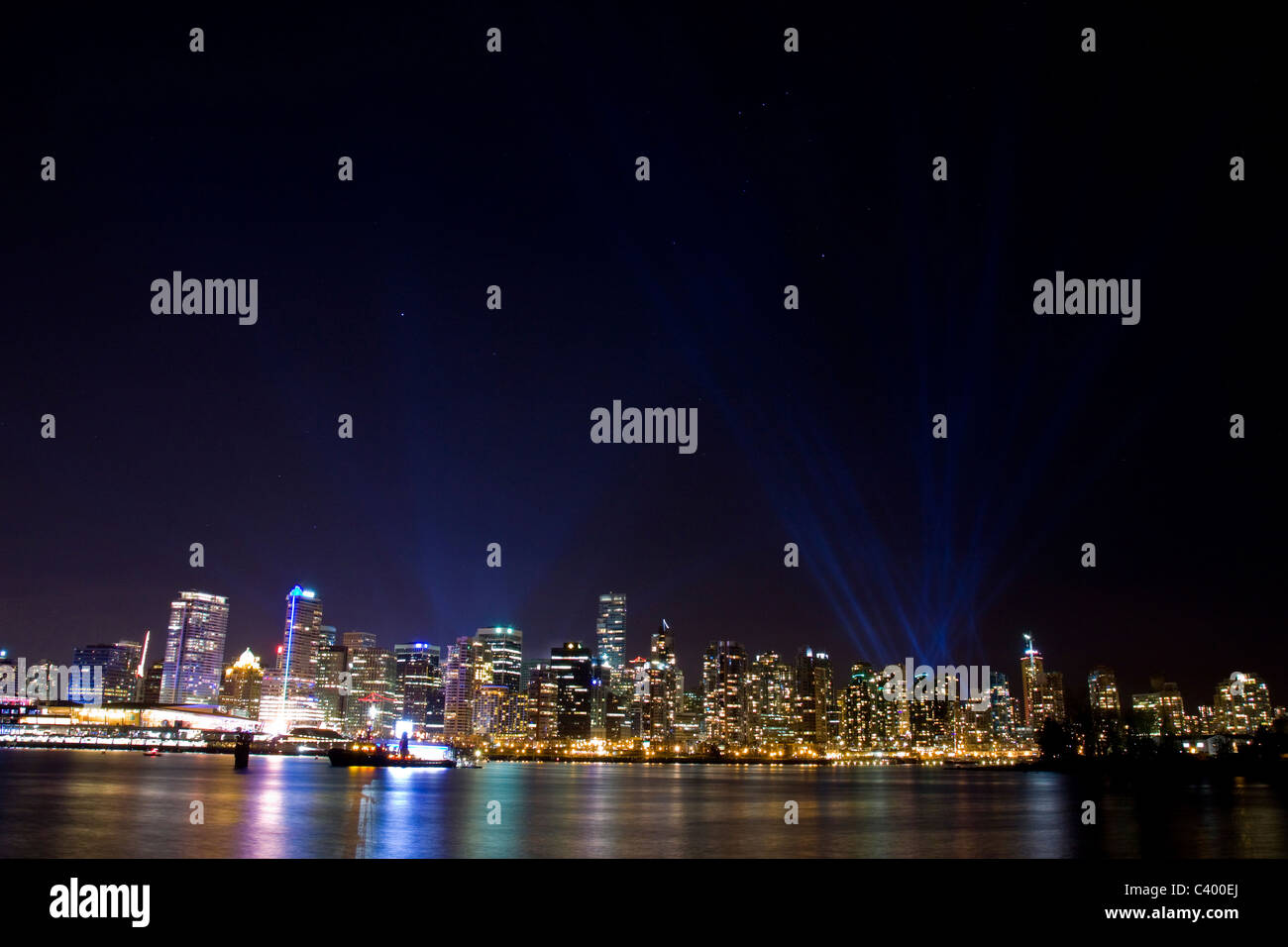 Projected spotlights behind Vancouver skyline during the 2010 Winter Olympic Games, Vancouver, Canada. Stock Photo