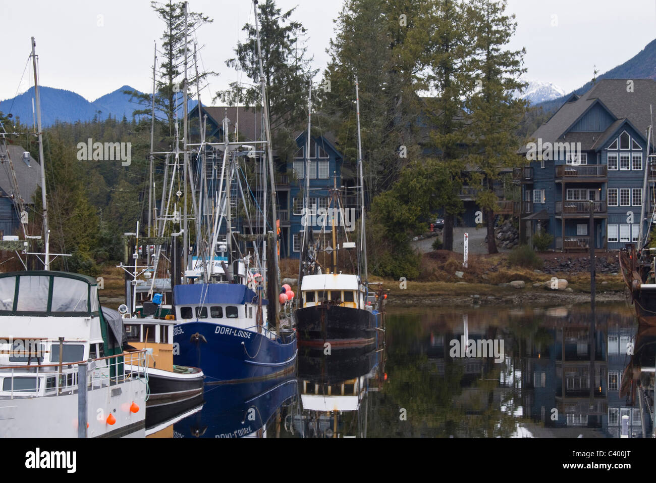 Fishing and pleasure boats reflected in little Ucluelet Harbour, Vancouver Island, British Columbia Stock Photo