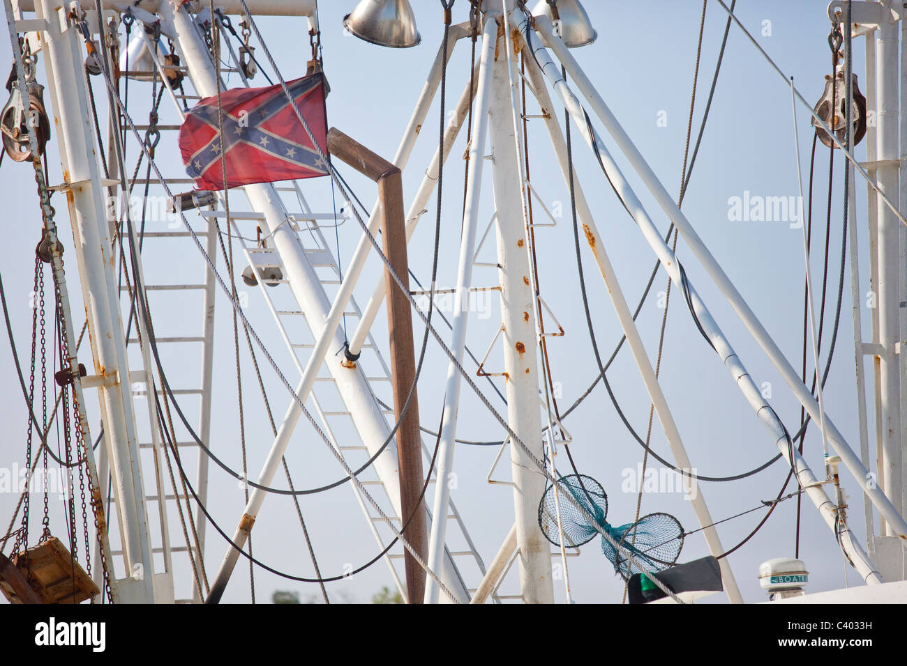 Confederate flag in the riggins of a crab boat in dock in Hampton, Virginia Stock Photo