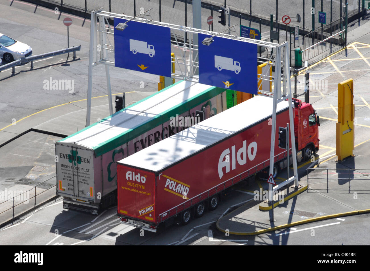 Polish lorry alongside Irish peat hgv both leaving Dover Ferry port passing detector panels Stock Photo