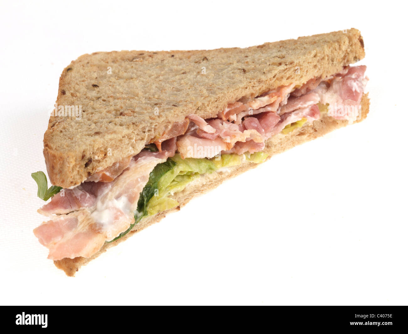 Freshly Prepared Bacon Lettuce And Tomato BLT Sandwich On Wholegrain Brown Bread Isolated Against A White Background With No People Stock Photo