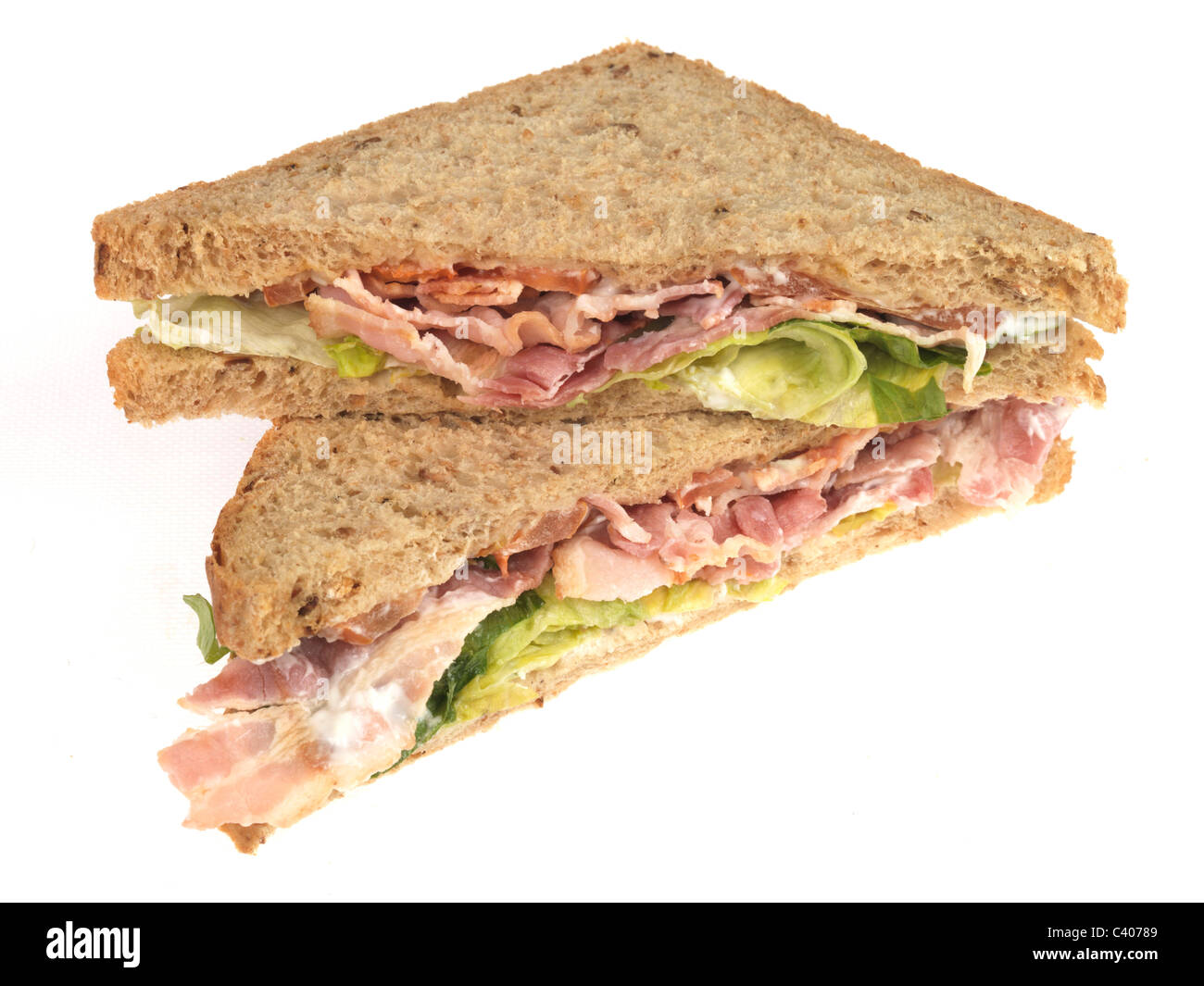 Freshly Prepared Bacon Lettuce And Tomato BLT Sandwich On Wholegrain Brown Bread Isolated Against A White Background With No People Stock Photo