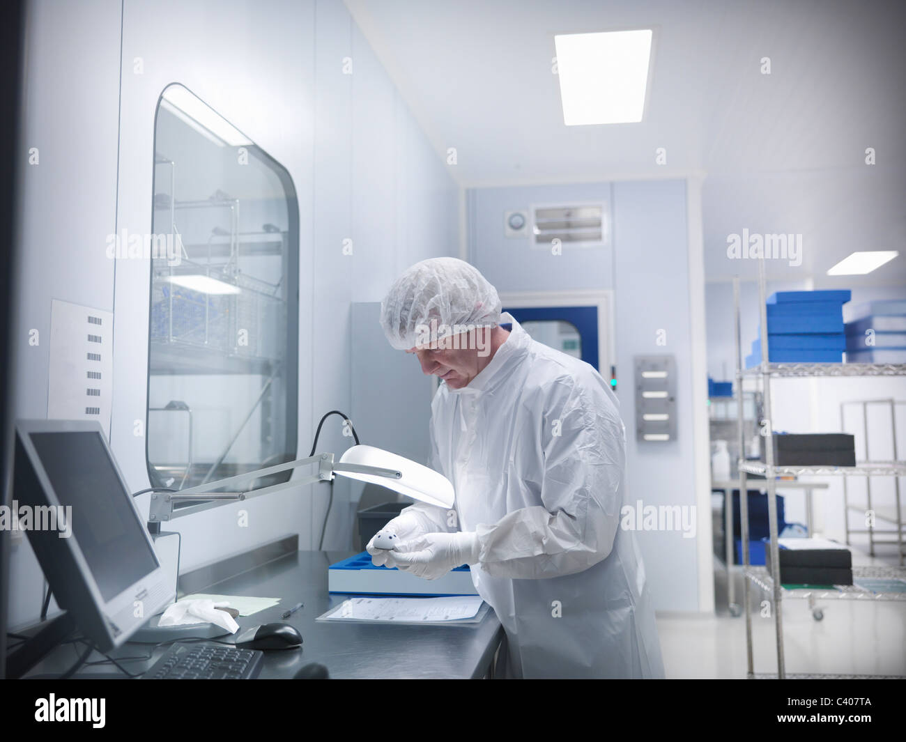 Scientist with product in clean room Stock Photo