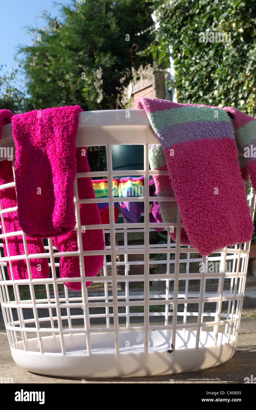 Socks draped on washing basket to dry in the sun Stock Photo - Alamy
