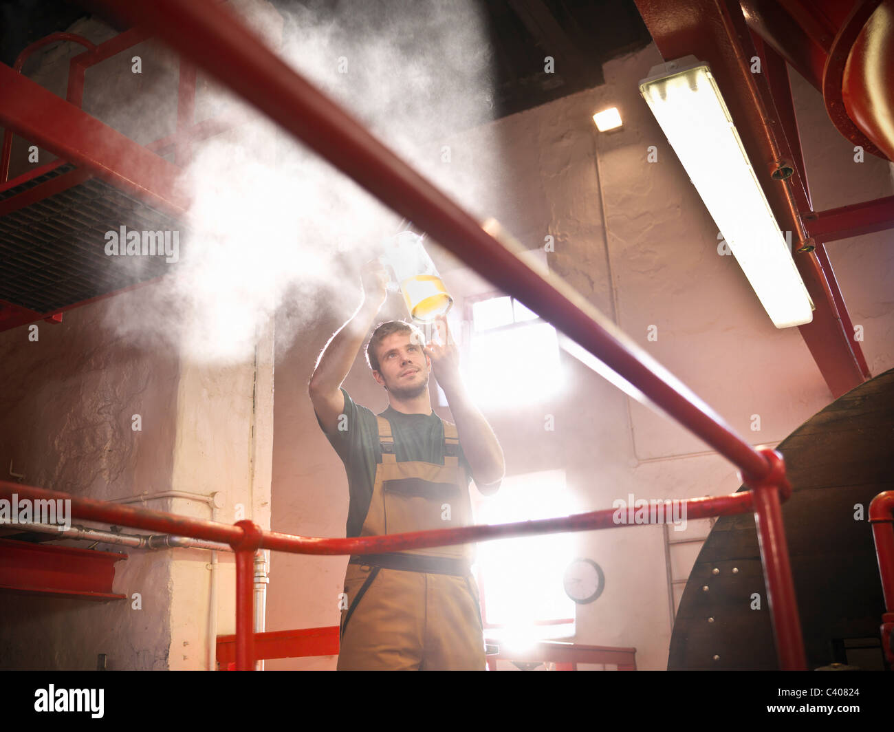 Worker in brewery inspecting sample Stock Photo