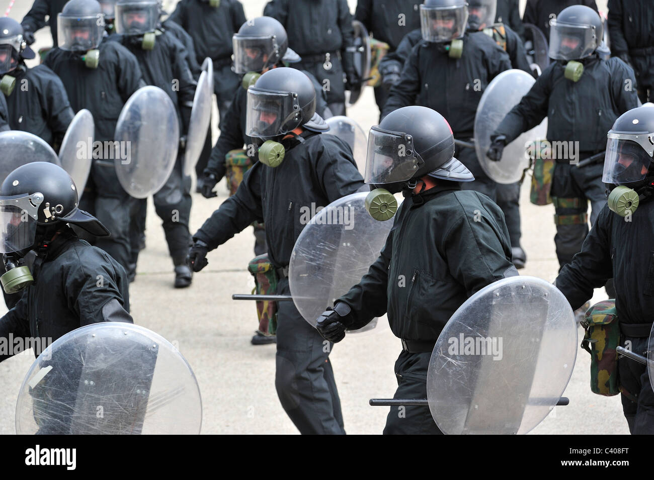 Riot squad police officers forming a protective barrier with riot shields during exercise of the Belgian army, Belgium Stock Photo