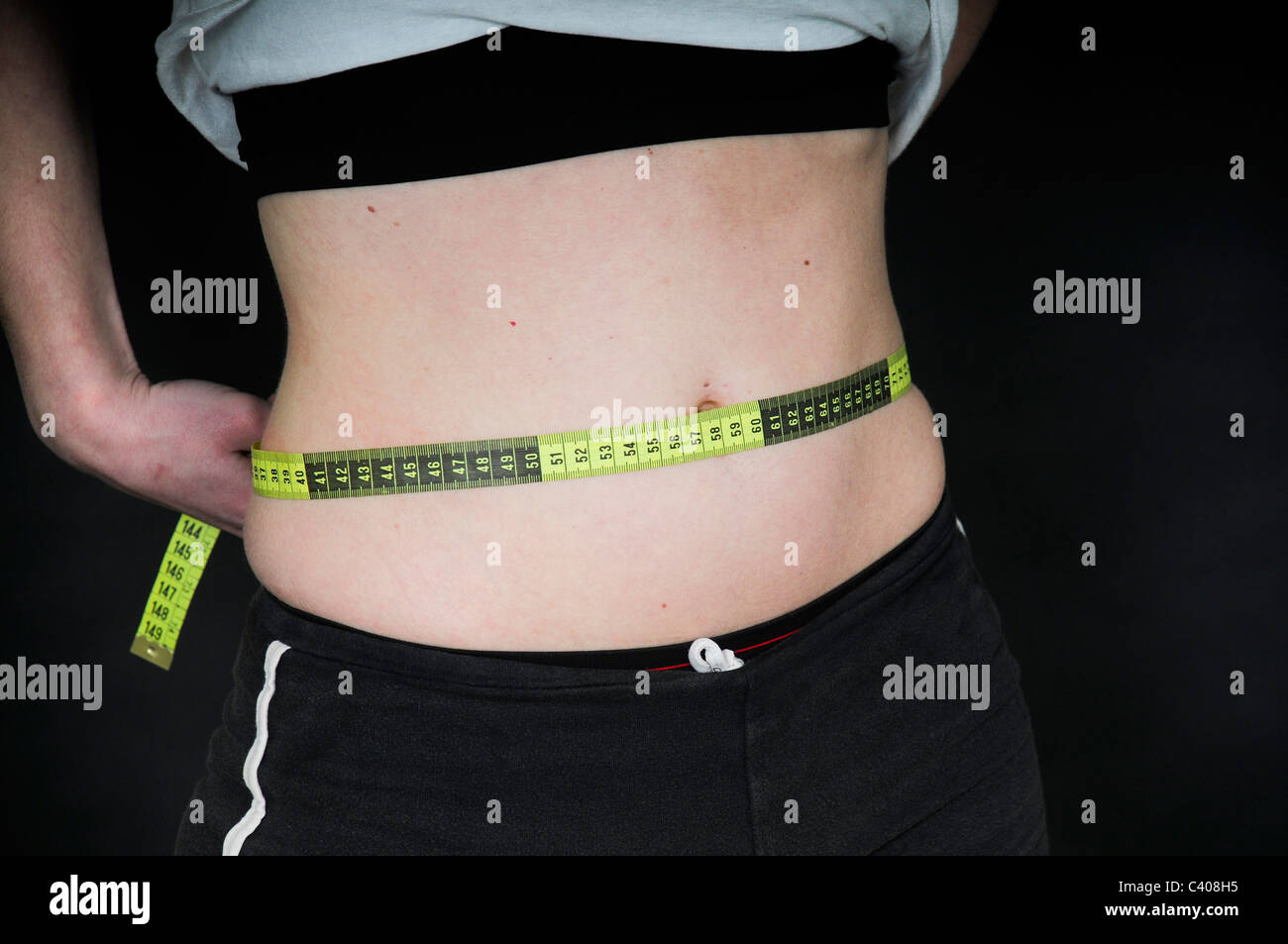 Young Woman measures her waist. Stock Photo