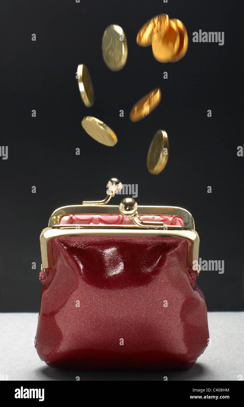 Coins falling into purse Stock Photo - Alamy