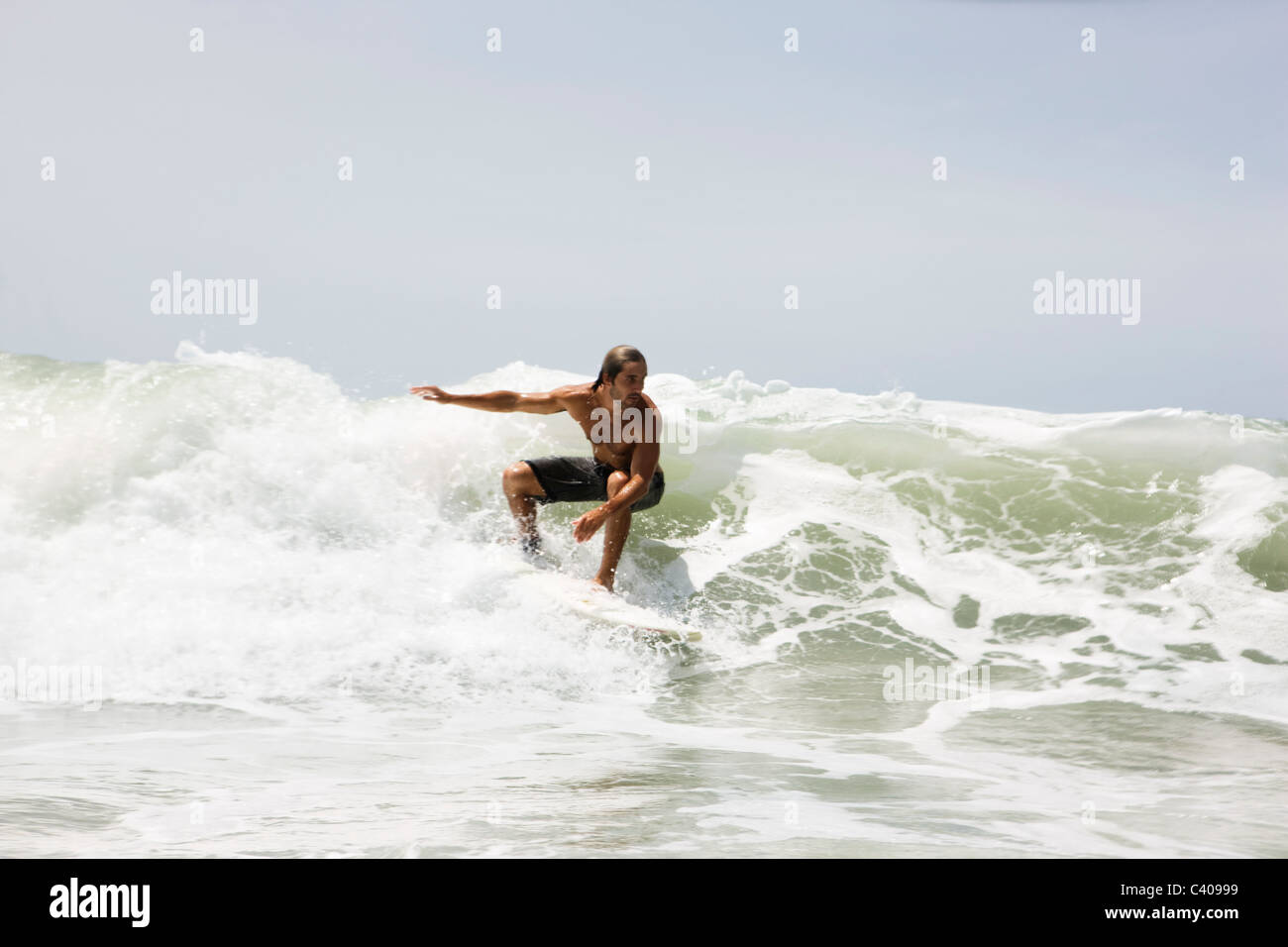 Guy surfing on wave Stock Photo