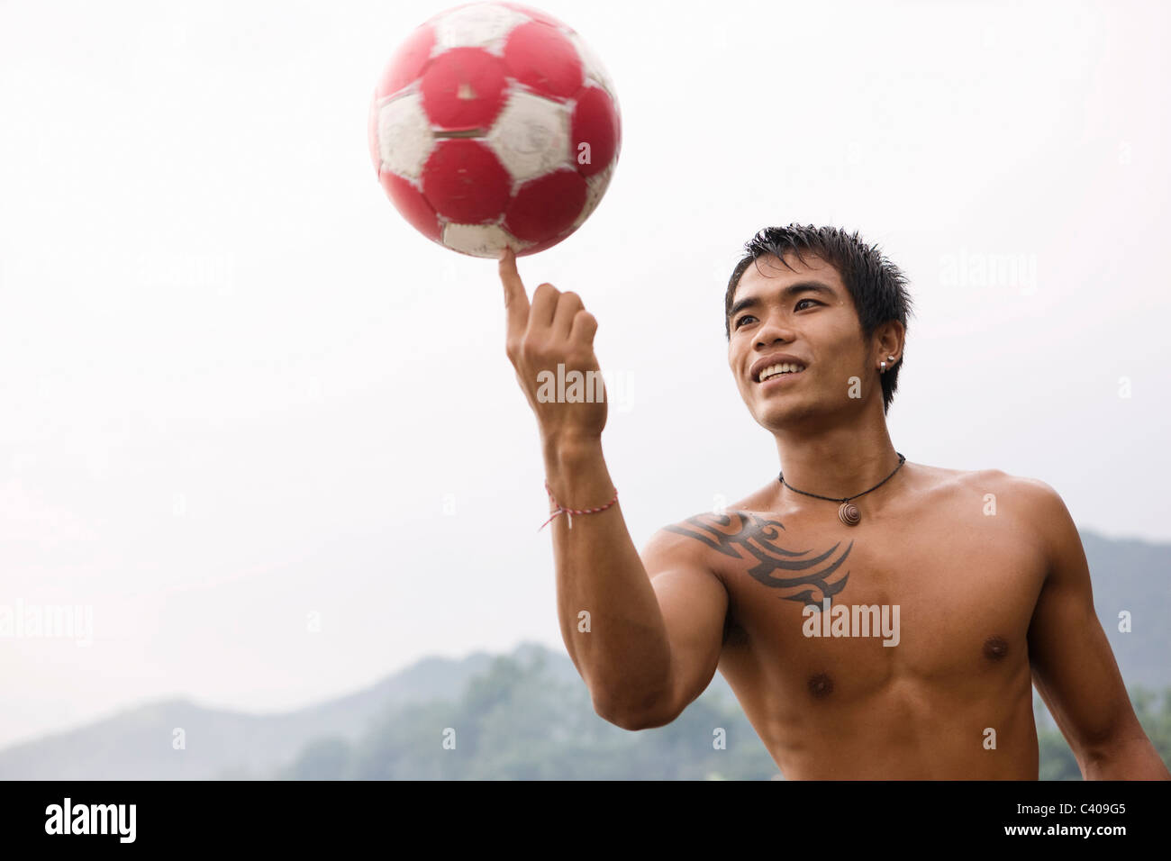Guy spinning football on finger Stock Photo Alamy
