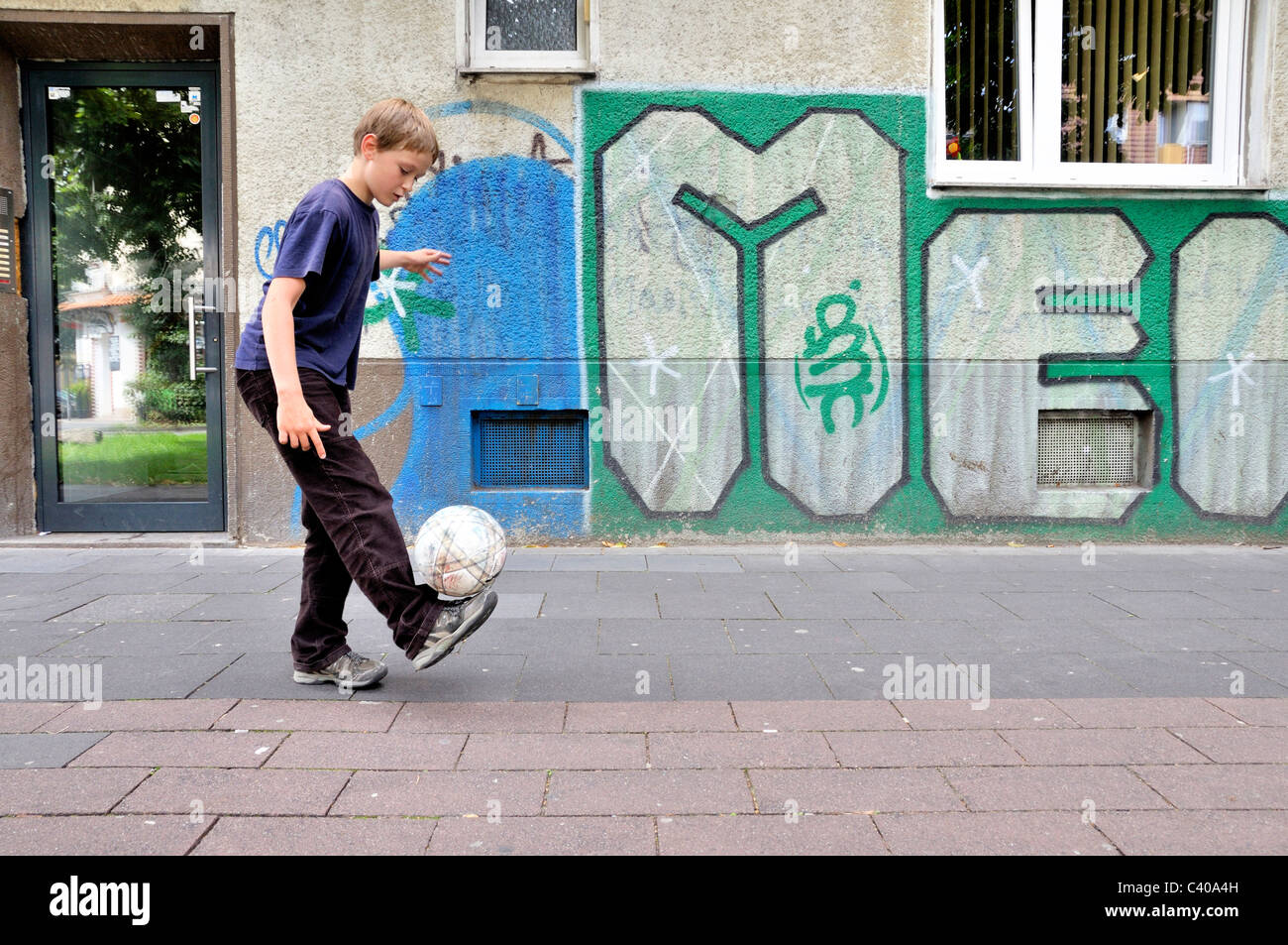 Germany, Europe, street football, football, soccer, boy, ball Stock Photo