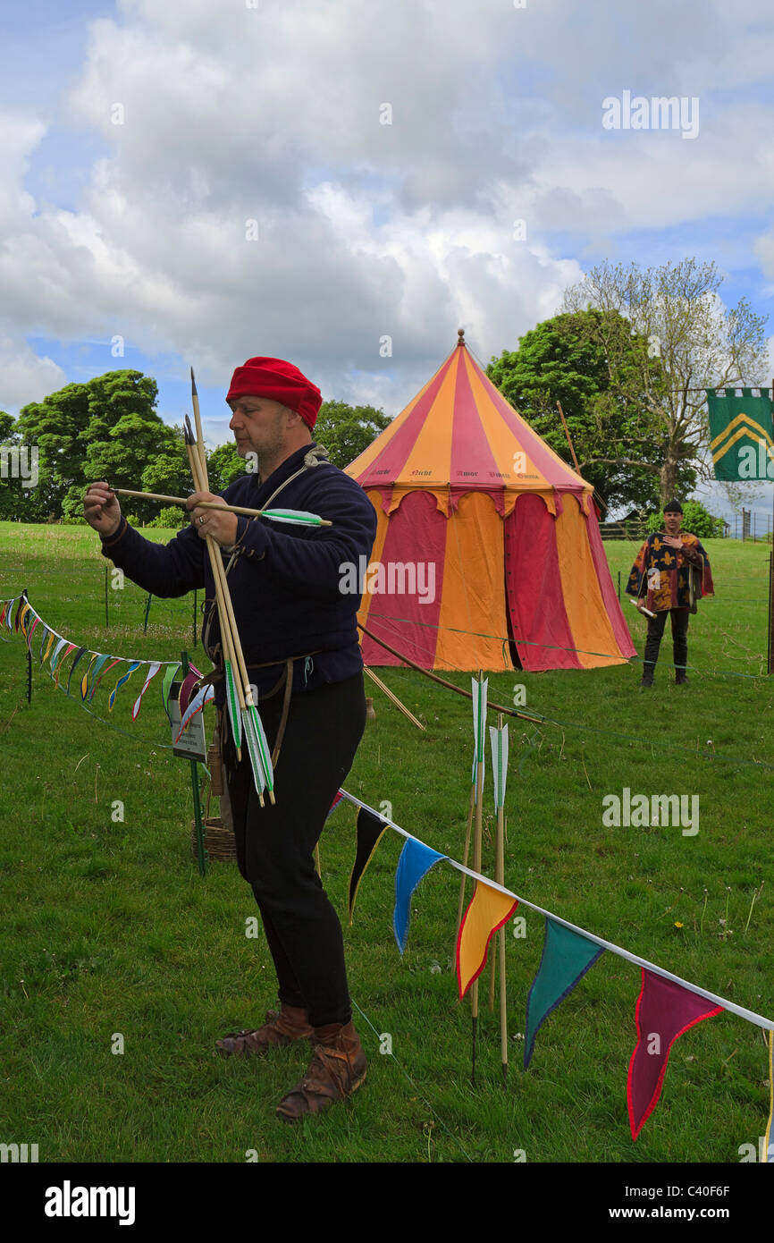Longbowman demonstrating the types of arrows at a medieval reenactment event. Stock Photo