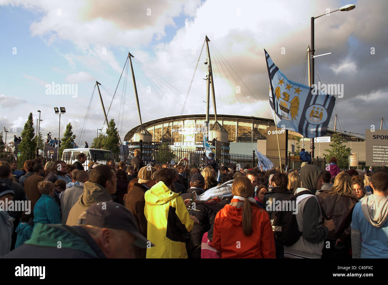 Fans gather outside the City of Manchester Stadium, now the Etihad,  for the Manchester City Cup Parade, 2011 Stock Photo