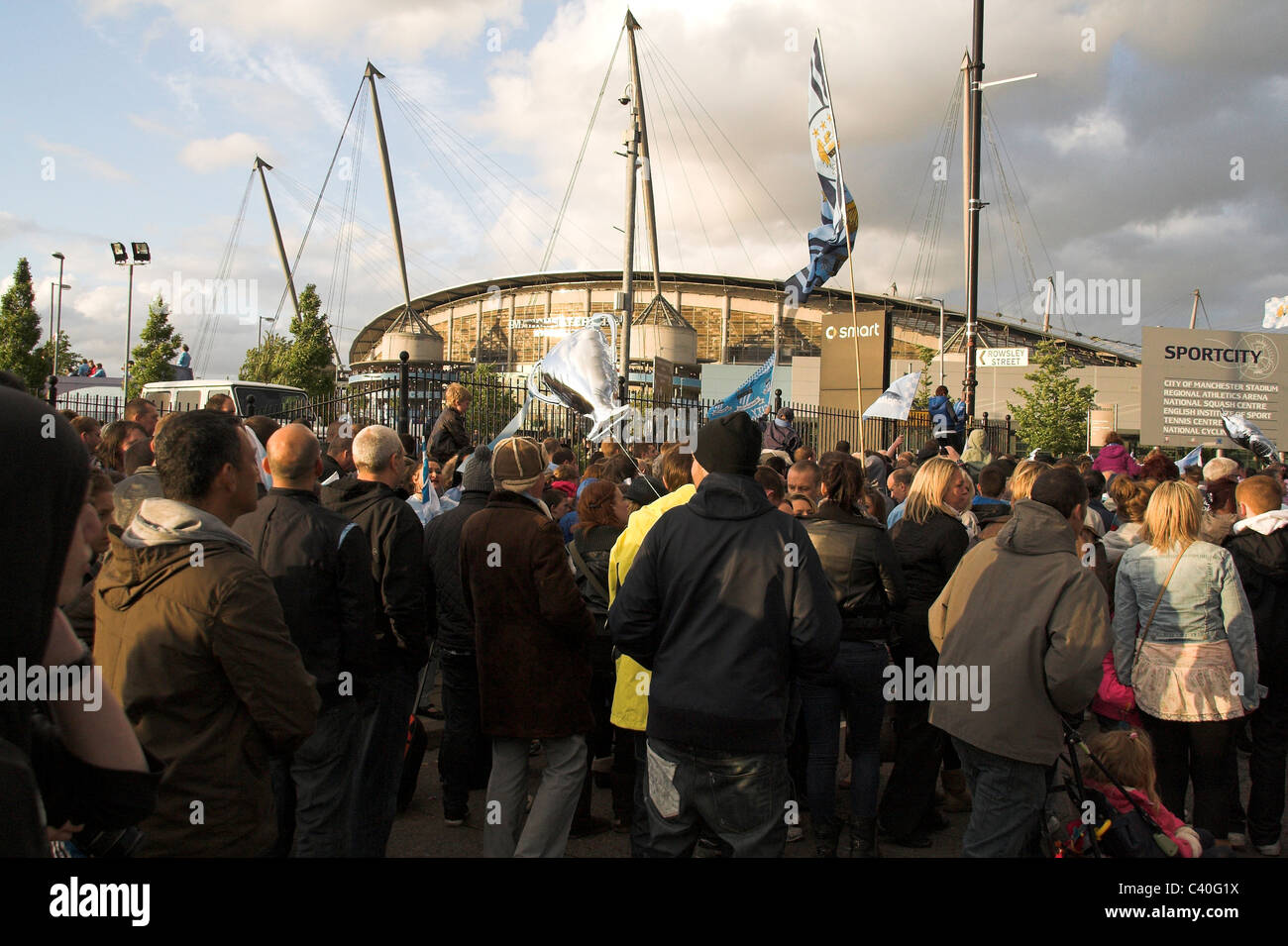 Fans gather outside the City of Manchester Stadium, now the Etihad,  for the Manchester City Cup Parade, 2011 Stock Photo