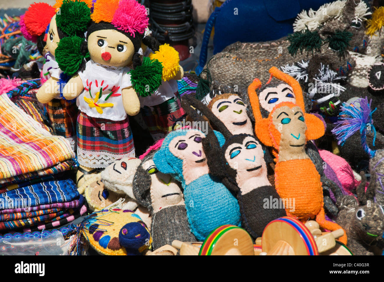 An assortment of colorful handmade dolls and animals is on display for sale by a street vendor in downtown Sayulita, Mexico. Stock Photo