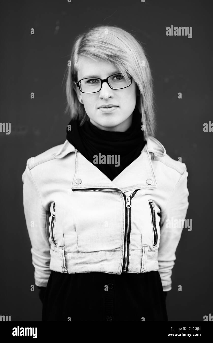 blond young woman with eyeglasses ,urban portrait, natural light and film f/x Stock Photo