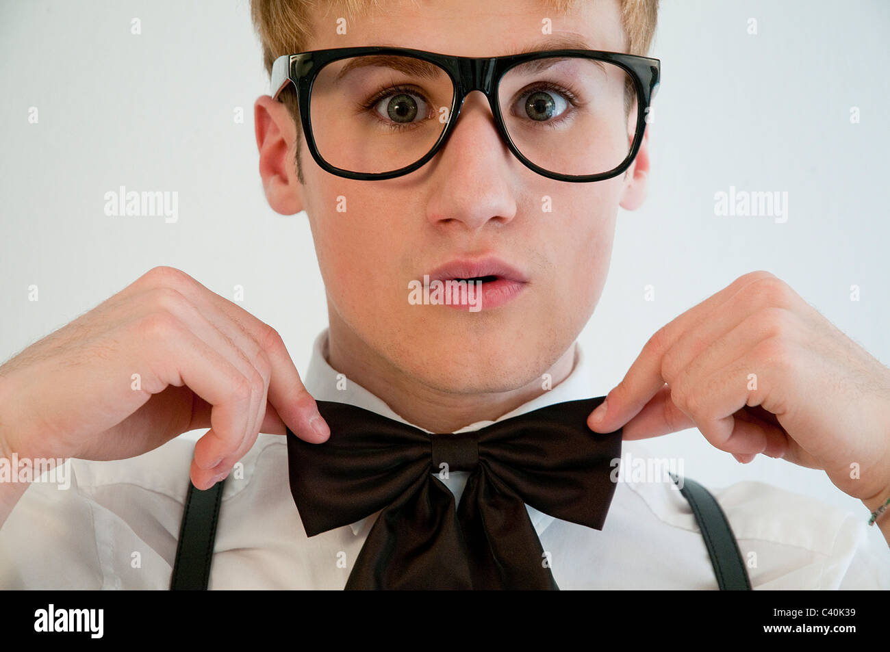 Young man wearing spectacles and bow tie. Close view. Stock Photo