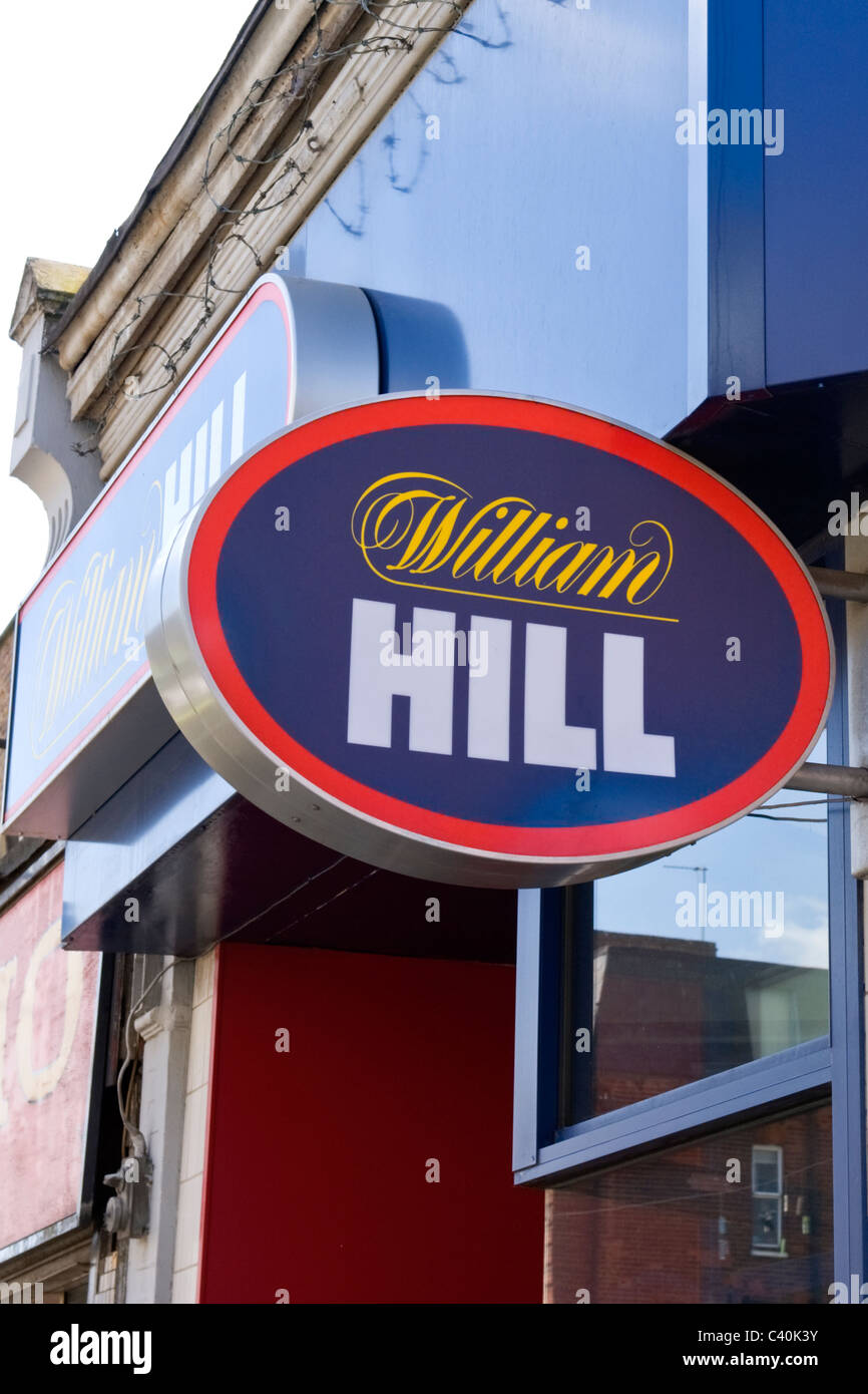London Islington Chapel Market William Hill betting shop or bookies facade barbed wire on top of store front logo sign signs facade frontage Stock Photo