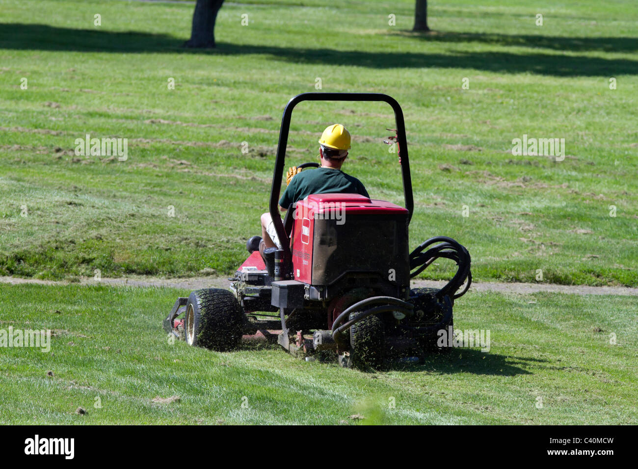 Golf course groundskeeper mowing the fairway Stock Photo Alamy Golf course groundskeeper mowing the fairway Stock Photo Alamy