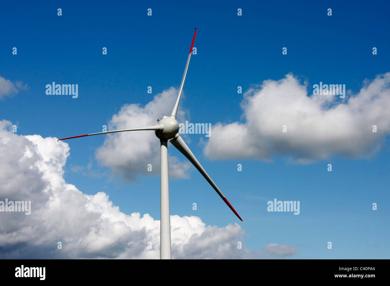 Wind turbine with bright blue sky and clouds in background Stock Photo ...