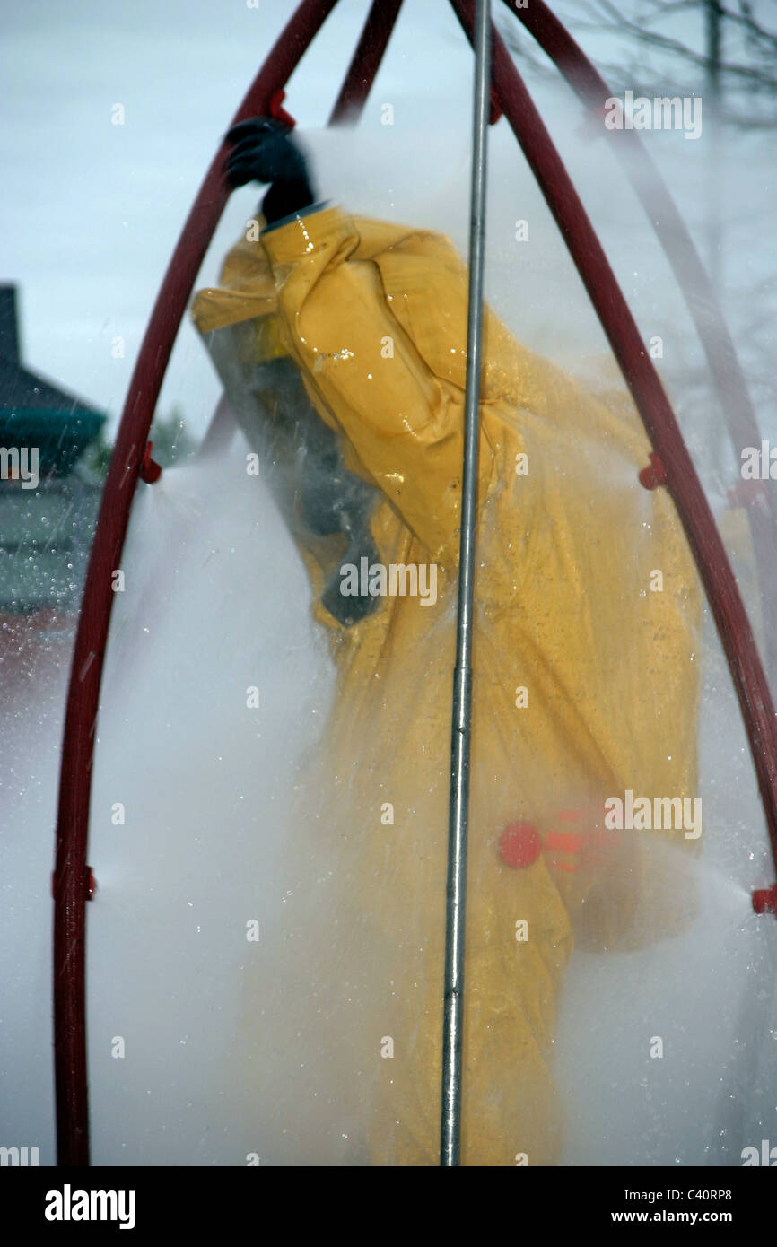 Firefighter practices using a decontamination shower Stock Photo Alamy