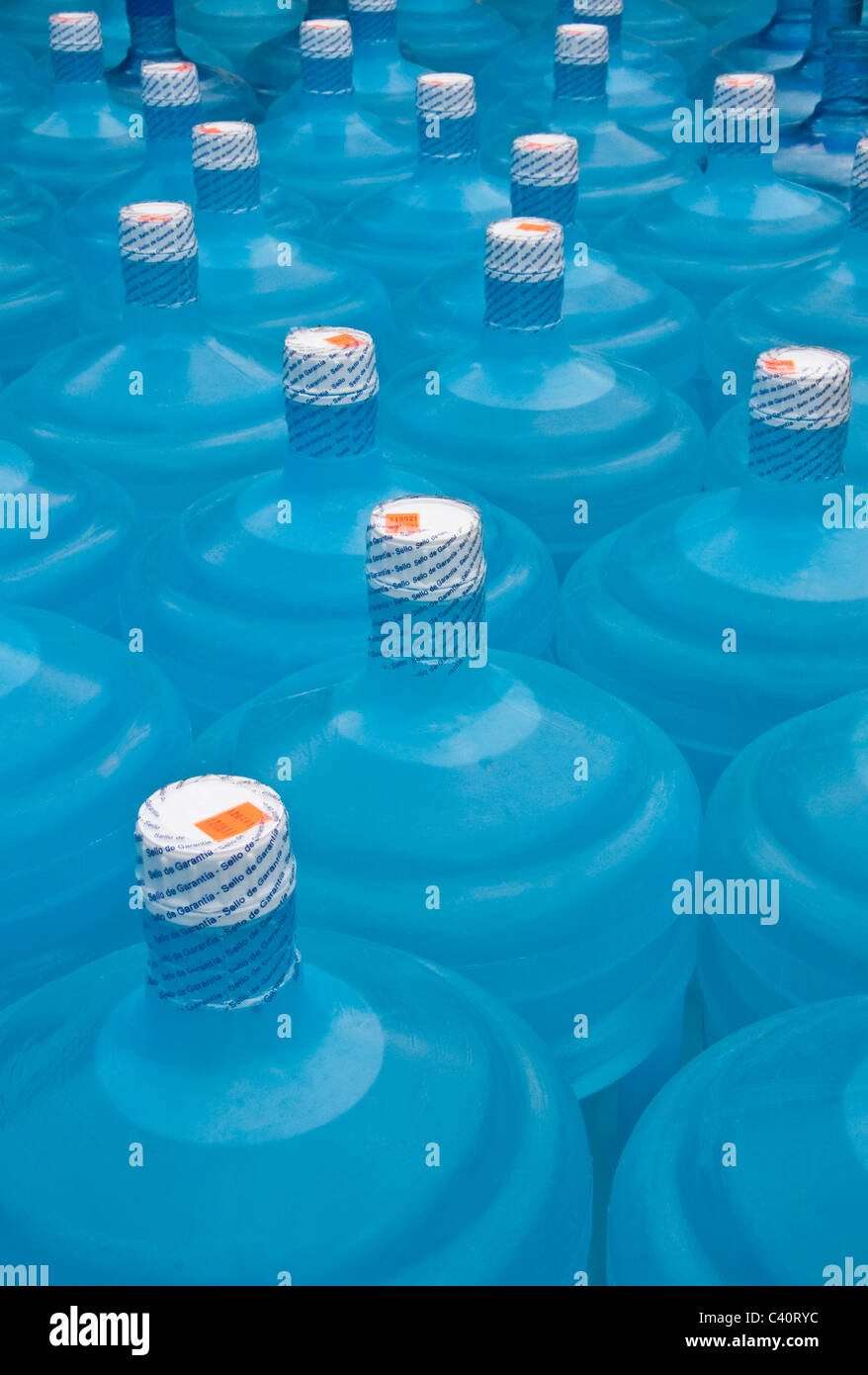 Jugs of drinking water in Central America with guarantee/warranty seals (sealed for protection) Stock Photo