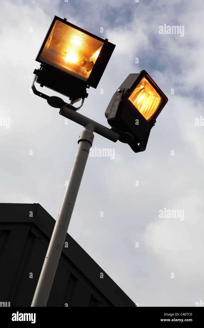 Lights on in daylight at business premises in the U.K. Stock Photo