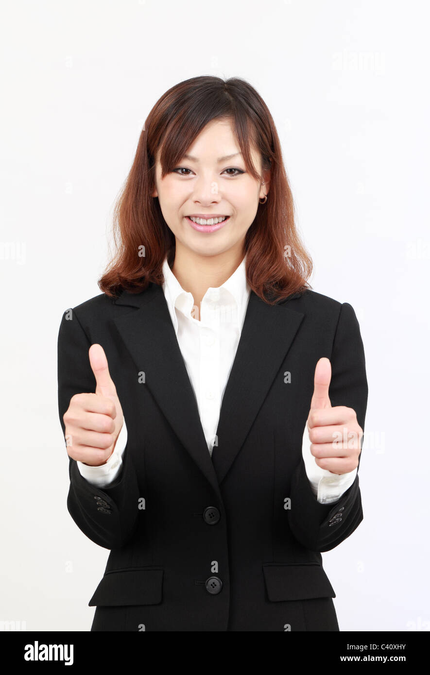 Smiling asian business woman showing thumbs up gesture Stock Photo - Alamy