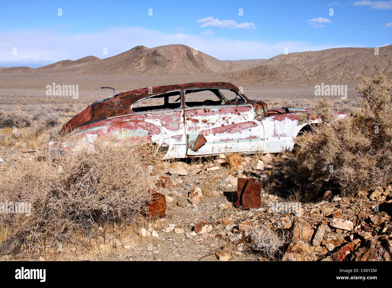 1947 Buick Roadmaster lies abandoned and rusting near Harrisburg and the Eureka Mine in Death Valley National Park. Stock Photo