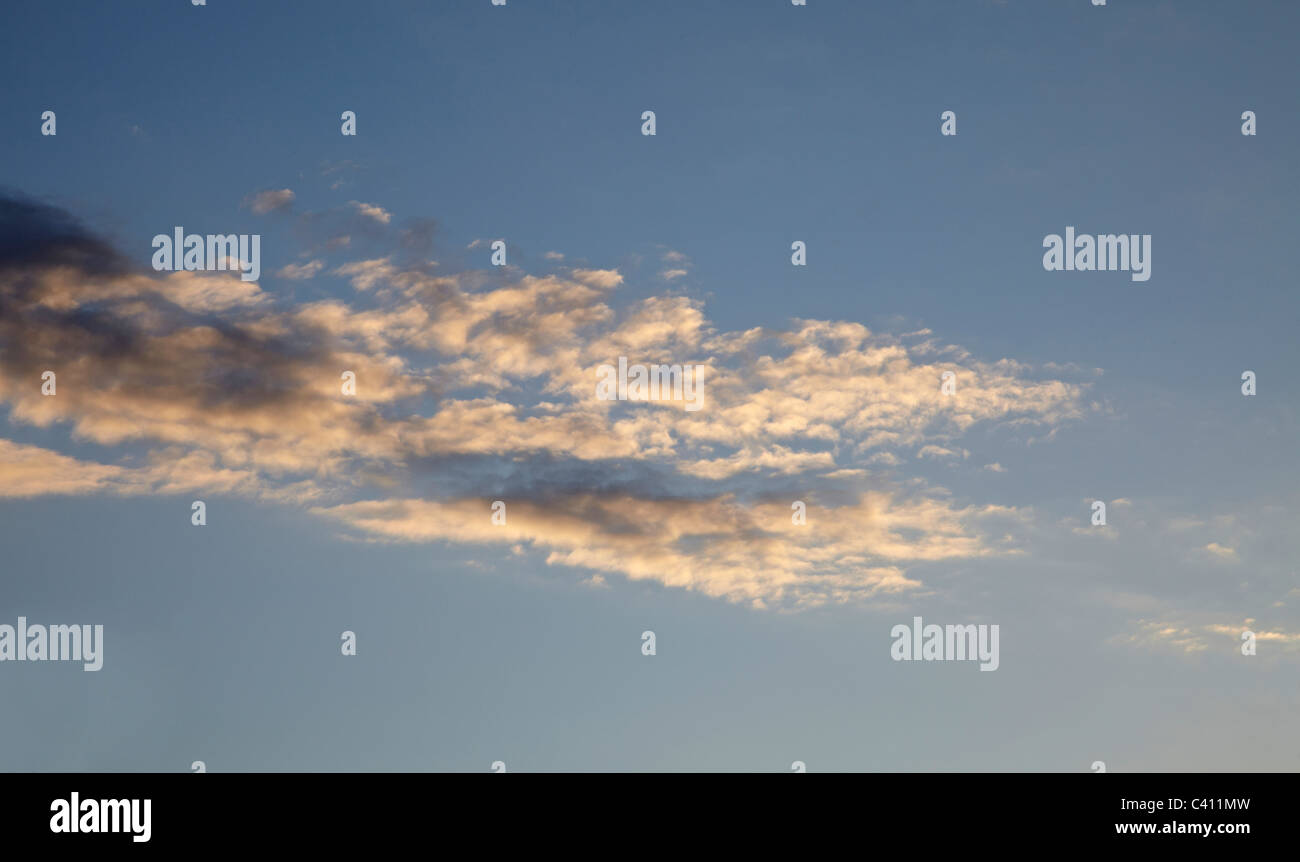 Landscape image of sunset. Looking up into sky with graduated effect, warm colours against darkening blue sky Stock Photo
