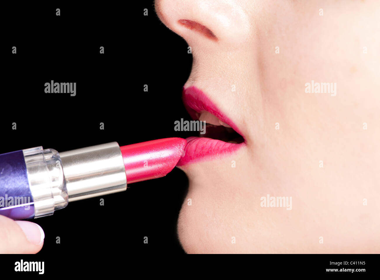woman applying lipstick, close up Stock Photo