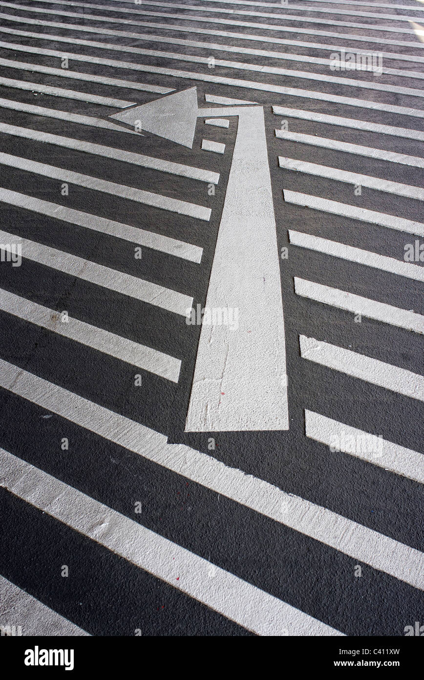 left hand turn arrow painted on the road Stock Photo