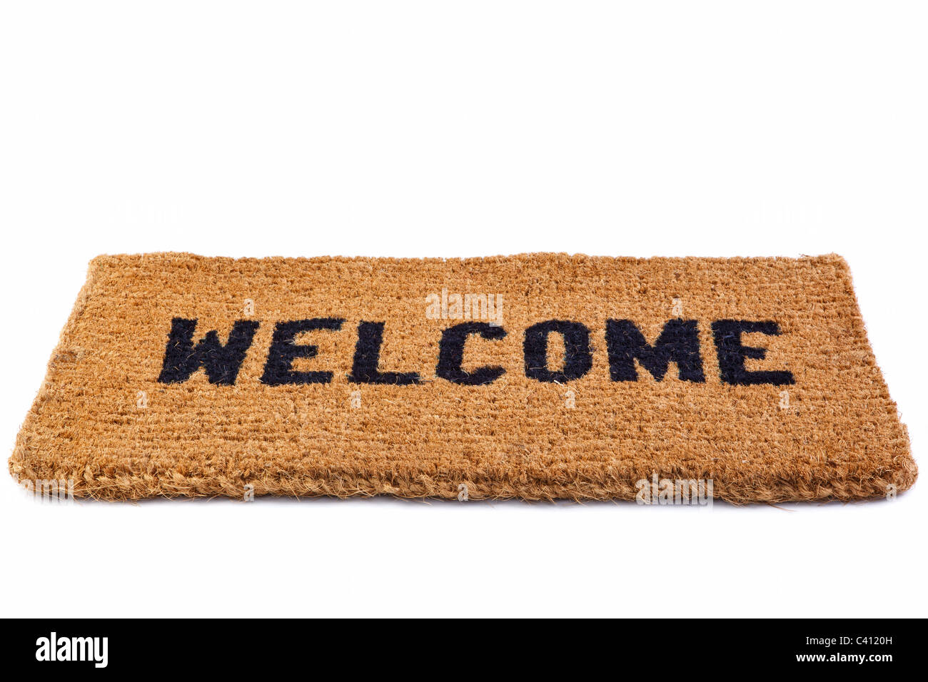 Photo of a welcome door mat isolated on a white background. Stock Photo