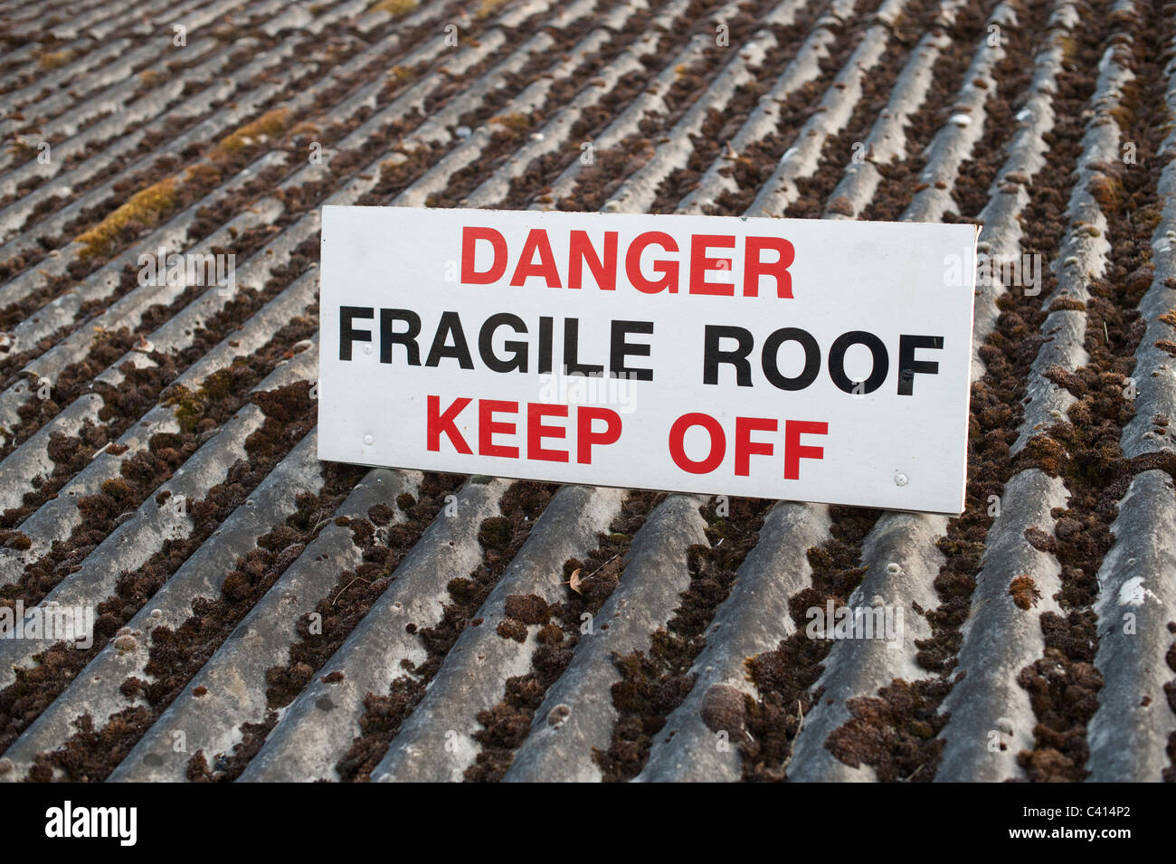 Danger fragile roof keep off sign uk Stock Photo
