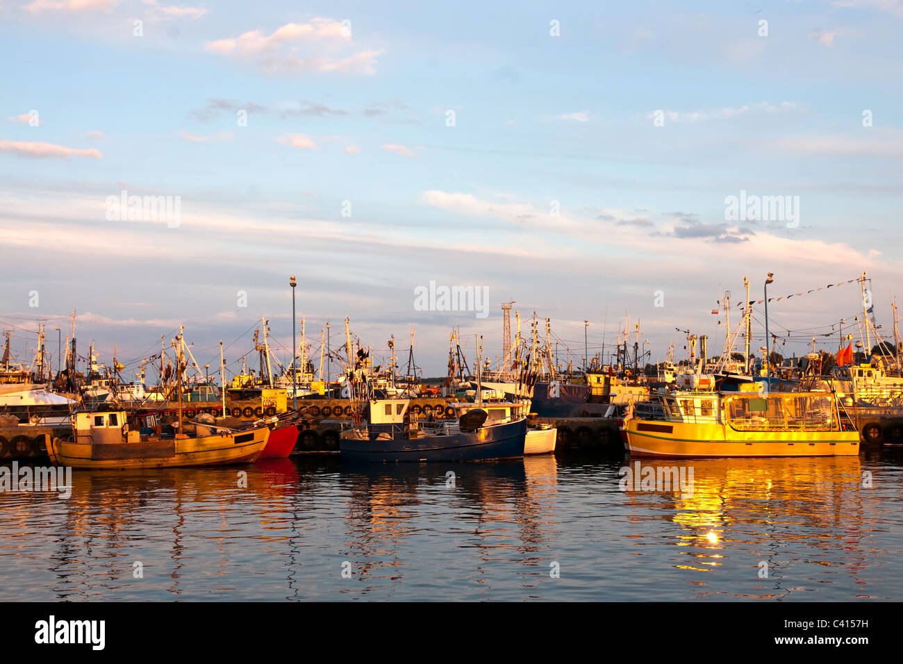 Marina at Sunset. Fishing boats and yachts in port. Stock Photo