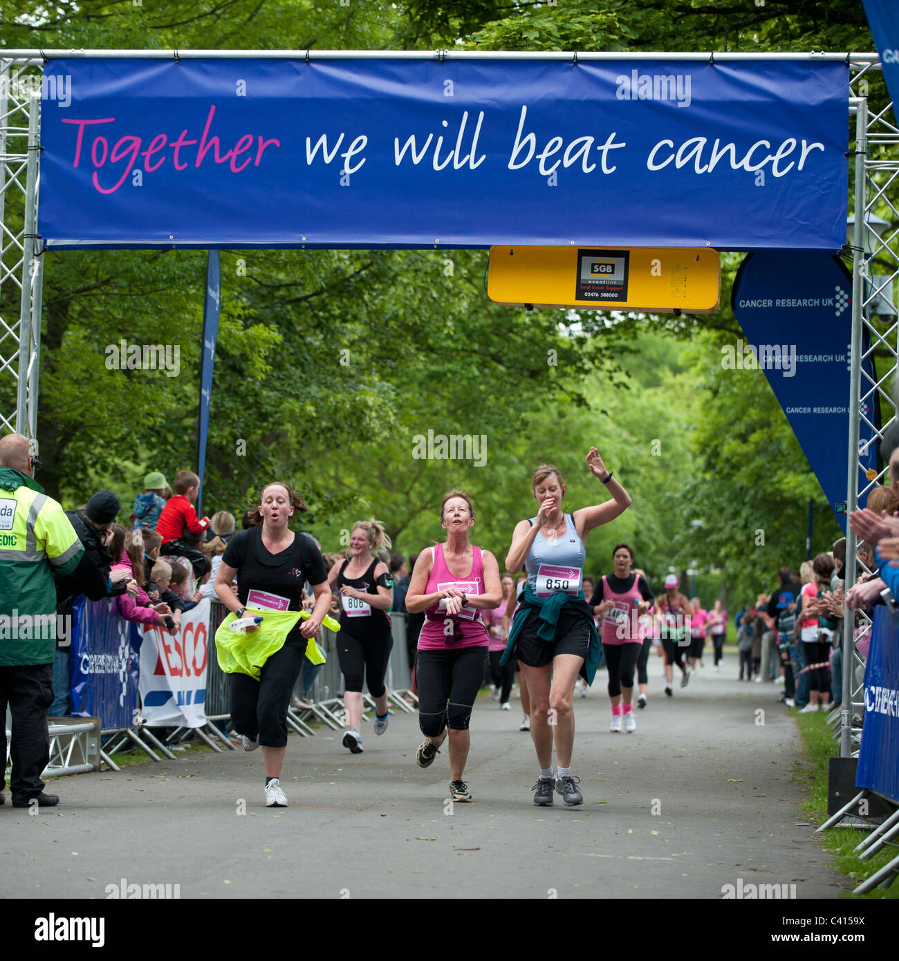 Race for Life - women running to raise money for cancer research charity - Aberystwyth Wales UK Stock Photo