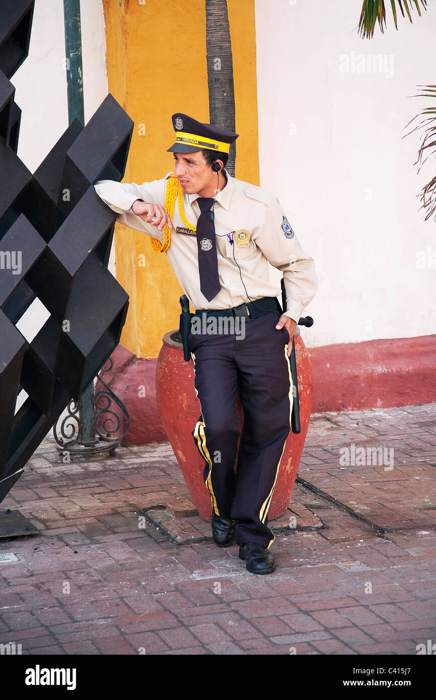 Policeman sitting down in cartegena columbia Stock Photo