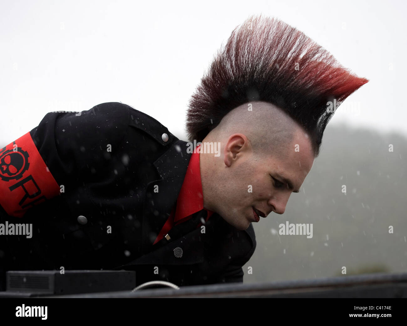 A man dressed as a punk rocker with a Rat Patrol arm band and a black and red Mohawk at the Frozen Dead Guy Festival Stock Photo