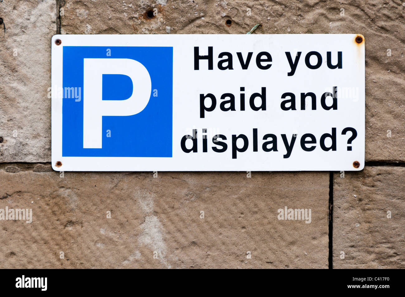 A warning sign reminding motorists to pay for a parking ticket and display it. Stock Photo