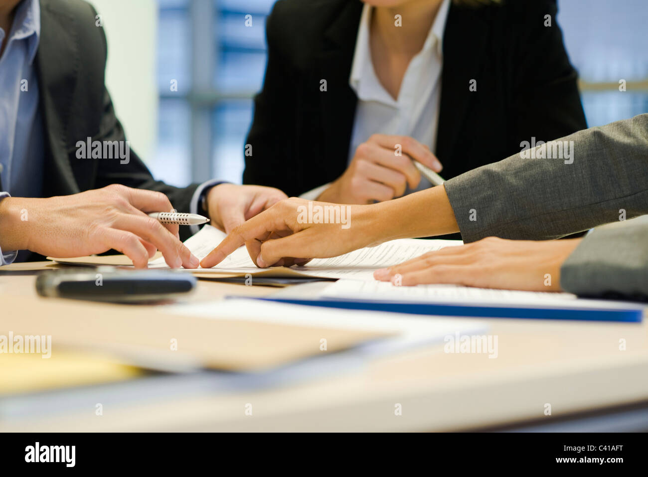 Executives negotiating in meeting, cropped Stock Photo