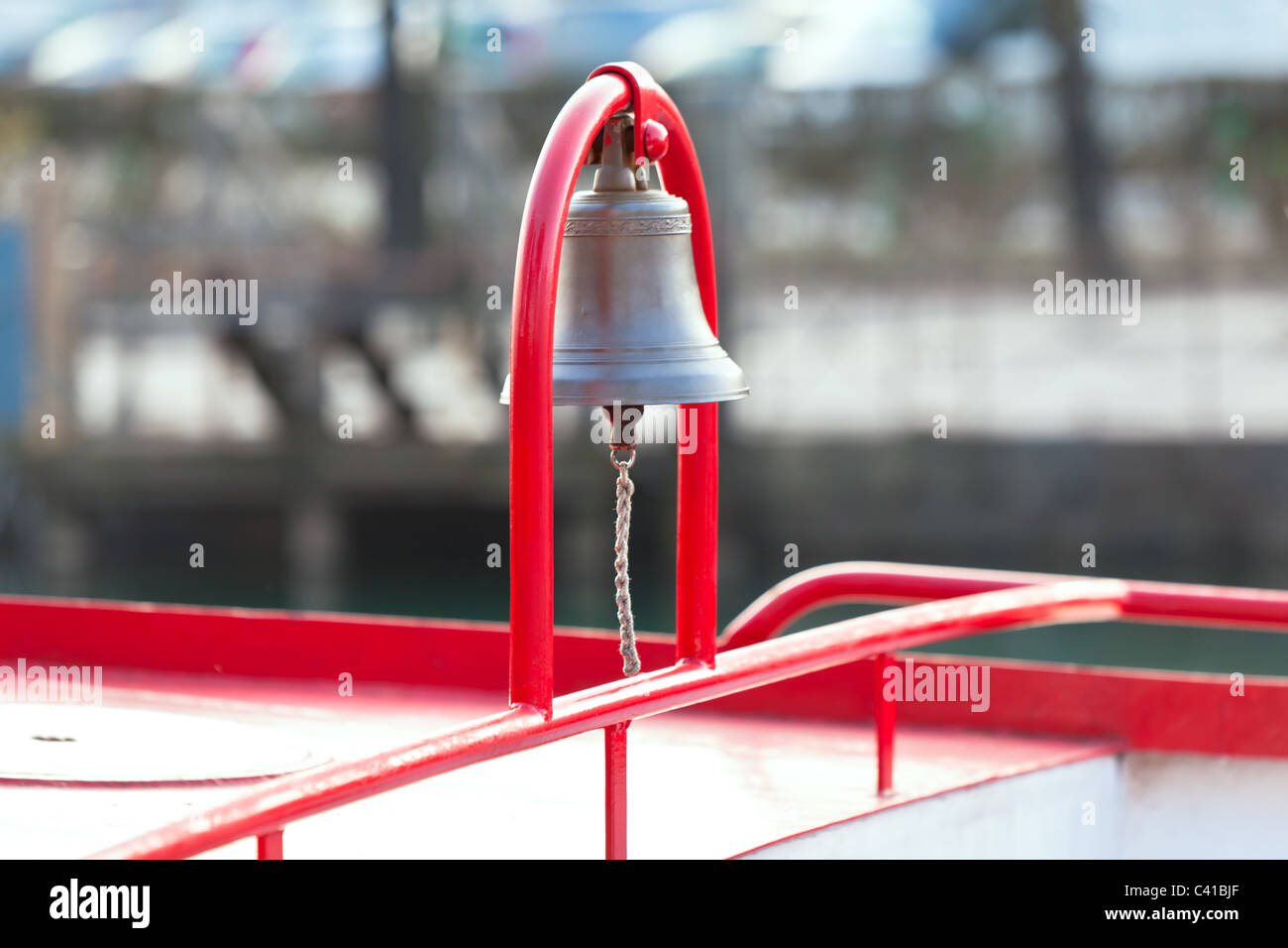 Ship Bell on red arc mount. horizontal shot Stock Photo Alamy