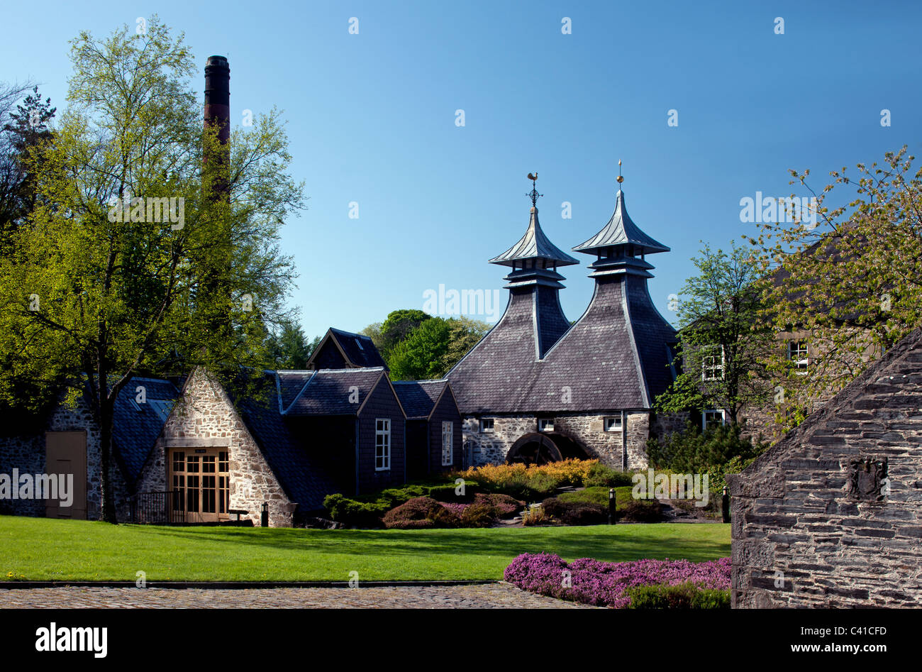 Springtime shot of Strathisla Distillery, with Spring flowers, in Keith, Banffshire, Scotland (Moray Firth) Stock Photo