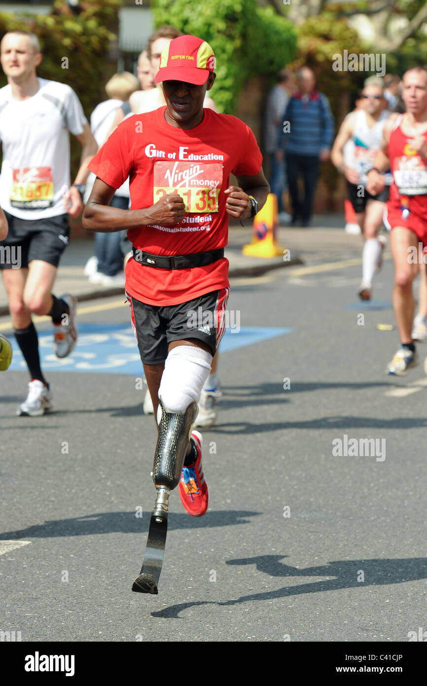 a Disabled Runner with a artificial leg takes part in the Virgin 2011 London Marathon seen here at 14 Miles Stock Photo