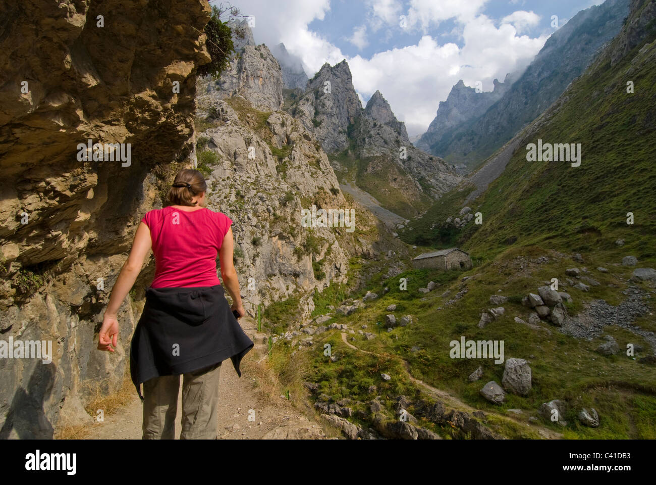 Walker on the dramatic footpath in the Garganta del Cares, Near Cain. Picos de Europa, Asturias. Stock Photo