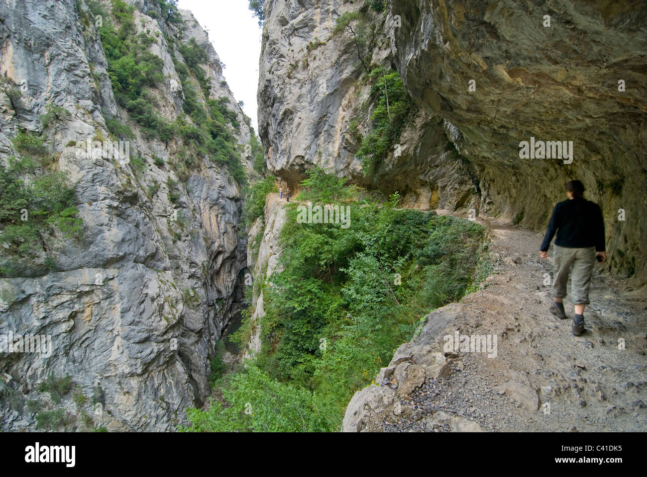 Walker on the dramatic footpath in the Garganta del Cares, Near Cain. Picos de Europa, Asturias. Stock Photo